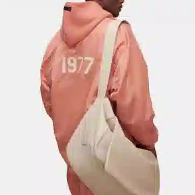 Fear of God Essentials FW22 1977 Nylon Coaches Jacket Coral Logo