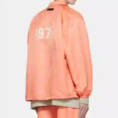 Fear of God Essentials FW22 1977 Nylon Coaches Jacket Coral Logo