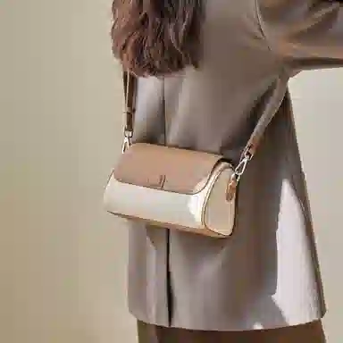 纳兰杜 包包女百搭高潮流小众品牌女士包包 牛皮拼合成革 圆筒包斜挎包单肩包 小号 女款 米白拼杏/可可棕