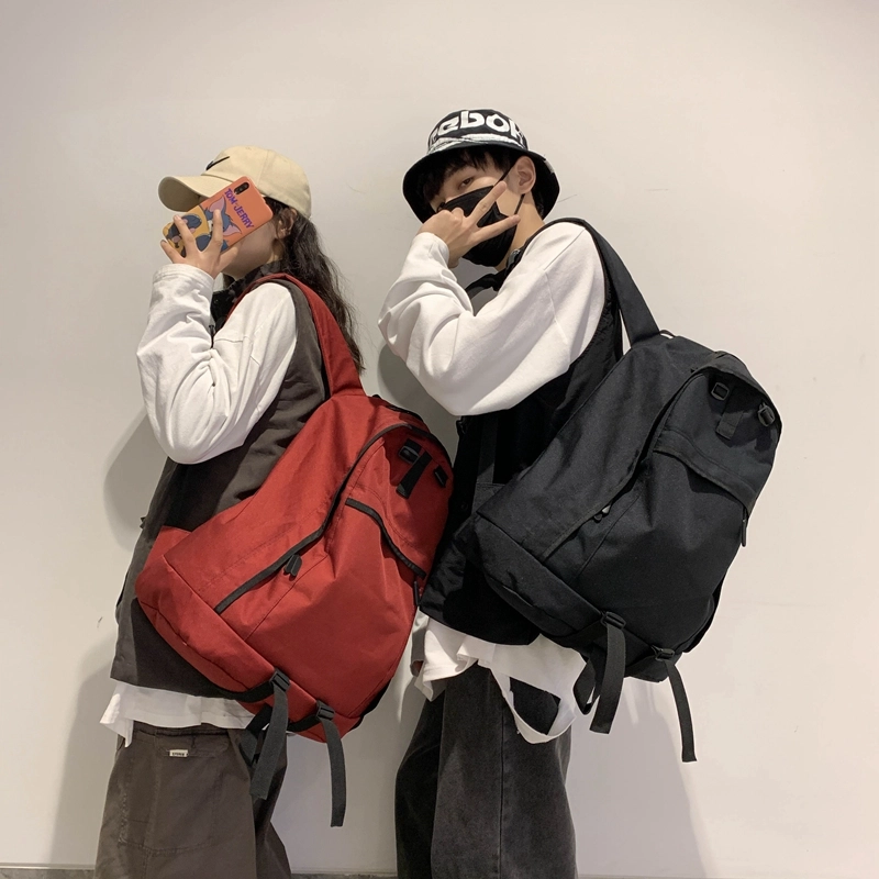 德力熊双肩包大容量休闲简约纯色百搭轻便三色可选双肩背包情侣男女通用 尼龙