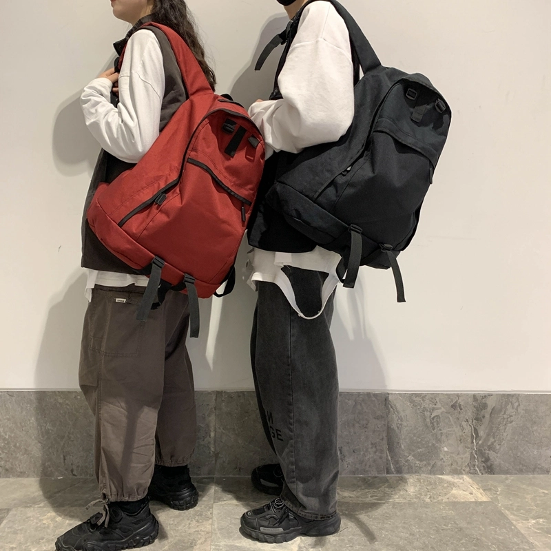 德力熊双肩包大容量休闲简约纯色百搭轻便三色可选双肩背包情侣男女通用 尼龙