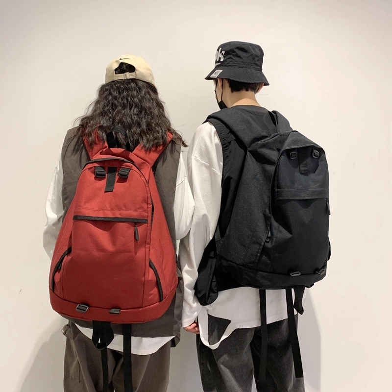 德力熊双肩包大容量休闲简约纯色百搭轻便三色可选双肩背包情侣男女通用 尼龙