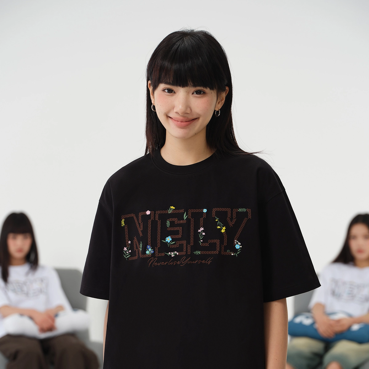 NELY logoT