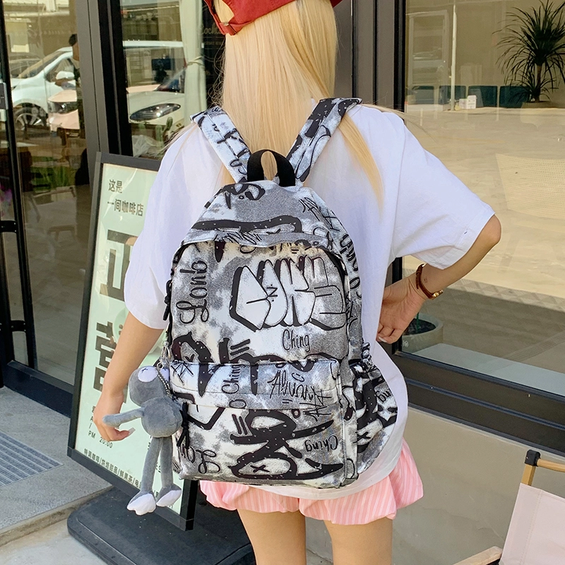泰格奴 涂鸦精美机能通勤旅行小清新轻便高颜值大容量背包初中高中大学生上课百搭书包 尼龙布 双肩包 男女同款情侣款 灰白色/黑白色