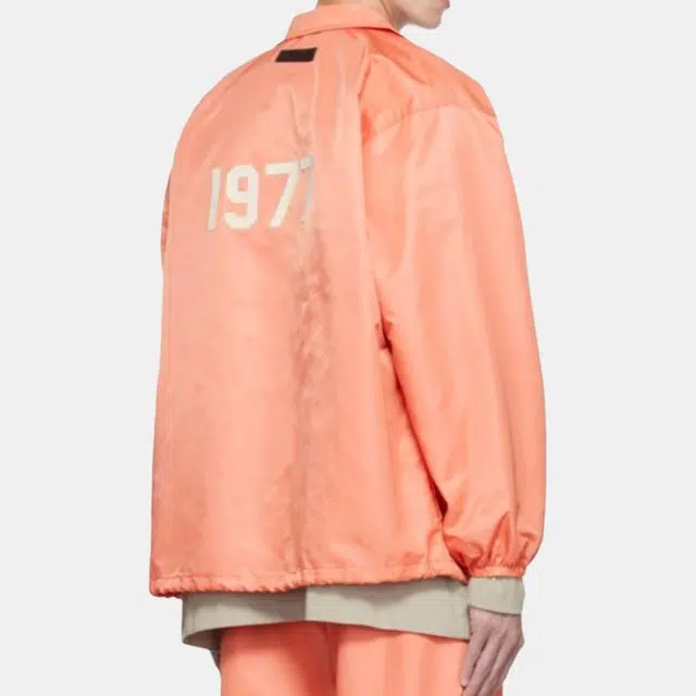 Fear of God Essentials FW22 1977 Nylon Coaches Jacket Coral Logo
