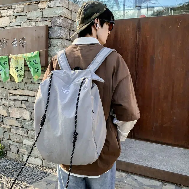 笛贝嘉 韩版简约大容量旅游背包抽绳纯色休闲运动学生书包 复合布 双肩包 男女同款情侣款 多色