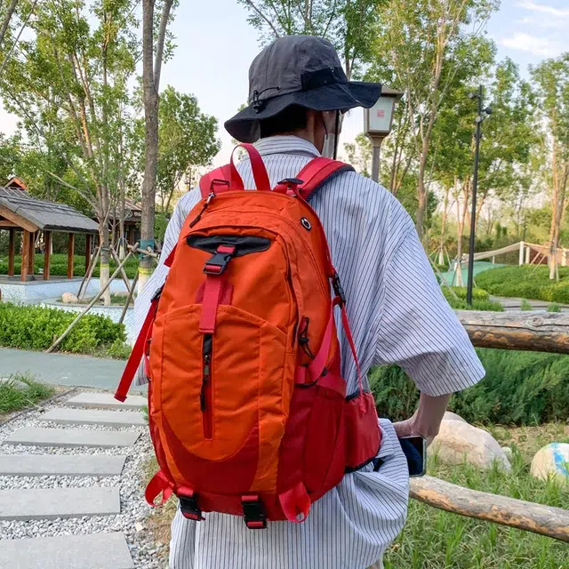 笛贝嘉 时尚简约轻便外出旅行 牛津布 双肩包 男女同款情侣款 桔红拼色