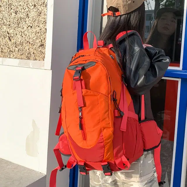 笛贝嘉 时尚简约轻便外出旅行 牛津布 双肩包 男女同款情侣款 桔红拼色