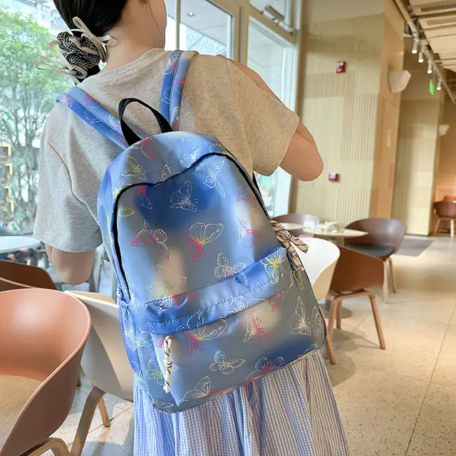 泰迪珍藏 学生书包时尚炫彩印花蝴蝶彩色背包小学初中大容量 尼龙 双肩包 女款 蓝色/紫色/黑色