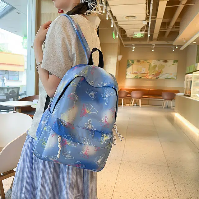泰迪珍藏 学生书包时尚炫彩印花蝴蝶彩色背包小学初中大容量 尼龙 双肩包 女款 蓝色/紫色/黑色