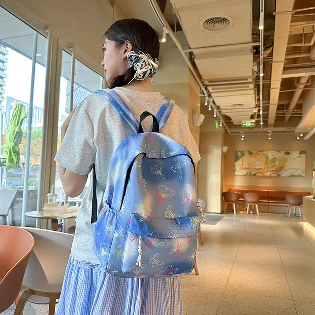 泰迪珍藏 学生书包时尚炫彩印花蝴蝶彩色背包小学初中大容量 尼龙 双肩包 女款 蓝色/紫色/黑色