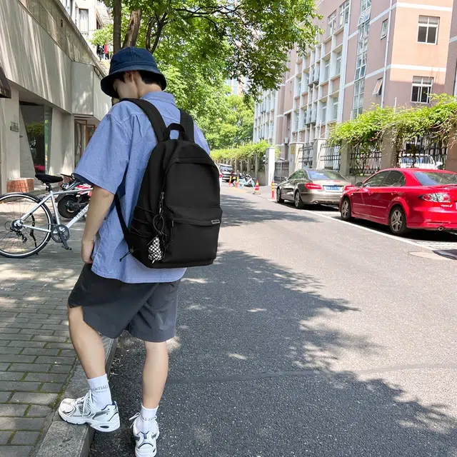 德力熊 大容量简约旅行电脑休闲高中大学生初中生 尼龙布 书包背包双肩包 常规 男女同款情侣款 黑/白