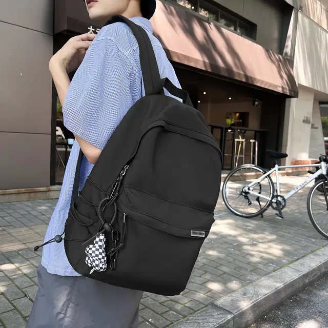 德力熊 大容量简约旅行电脑休闲高中大学生初中生 尼龙布 书包背包双肩包 常规 男女同款情侣款 黑/白