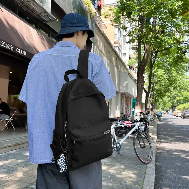 德力熊 大容量简约旅行电脑休闲高中大学生初中生 尼龙布 书包背包双肩包 常规 男女同款情侣款 黑/白