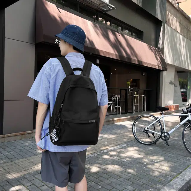 德力熊 大容量简约旅行电脑休闲高中大学生初中生 尼龙布 书包背包双肩包 常规 男女同款情侣款 黑/白