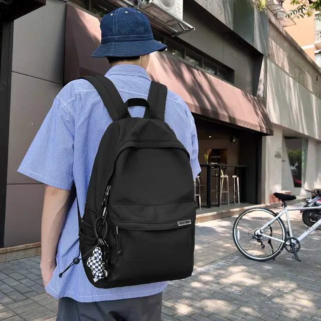 德力熊 大容量简约旅行电脑休闲高中大学生初中生 尼龙布 书包背包双肩包 常规 男女同款情侣款 黑/白