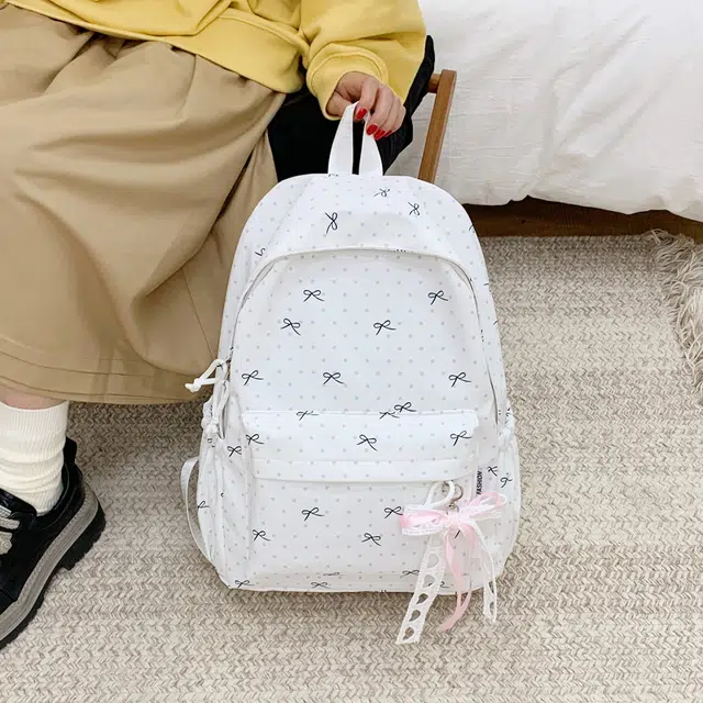 南潇湘 高颜值蝴蝶结格纹卡通可爱大容量上课书包通勤时尚潮流防水耐磨轻便百搭背包 尼龙布 双肩包 男女同款情侣款 白色/蓝色/粉色